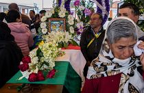 People mourn next to the coffin with the remains of Mexican environmentalist Homero Gomez González, during his funeral in El Rosario village, Mexico.