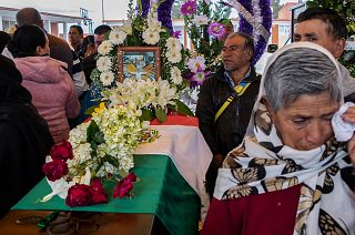 People mourn next to the coffin with the remains of Mexican environmentalist Homero Gomez González, during his funeral in El Rosario village, Mexico.