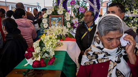People mourn next to the coffin with the remains of Mexican environmentalist Homero Gomez González, during his funeral in El Rosario village, Mexico.