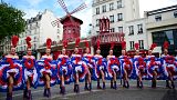 Dancers from the Moulin Rouge cabaret pose for photographers, on May 17, 2021 in Paris