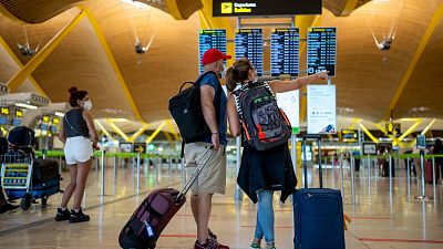 Passengers check the departure screen at Adolfo Suarez-Barajas airport in Madrid, Spain, July 9, 2021. Passengers check the departure screen at Adolfo Suarez-Barajas airport in Madrid, Spain, July 9, 2021.