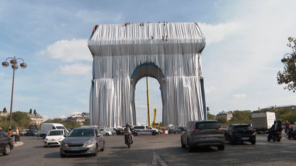Parisians, tourists admire wrapping of Arc de Triomphe, tribute to Christo