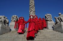 A Red Rebels brigade of the XR-Nordic Rebellion group stage a protest for the climate and against oil extraction in Norway in the Vigeland Park in Oslo on August 23, 2021.
