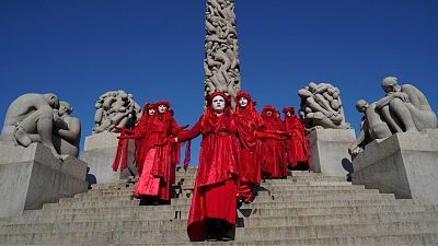 A Red Rebels brigade of the XR-Nordic Rebellion group stage a protest for the climate and against oil extraction in Norway in the Vigeland Park in Oslo on August 23, 2021. A Red Rebels brigade of the XR-Nordic Rebellion group stage a protest for the climate and against oil extraction in Norway in the Vigeland Park in Oslo on August 23, 2021.