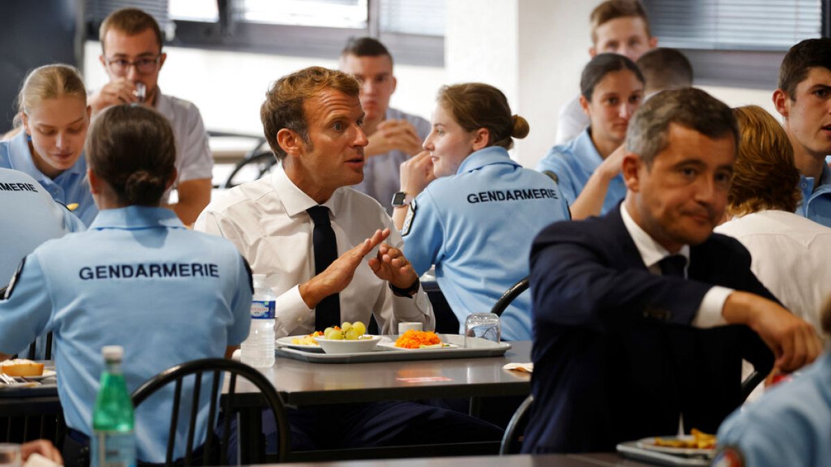 French President Emmanuel Macron and French Interior Minister Gerald Darmanin, right, have lunch with Gendarmes at the Roubaix police academy, northern France, Sept. 14, 2021.