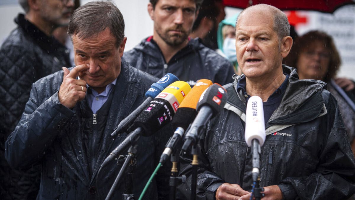 In this Tuesday, Aug.3, 2021 file photo Armin Laschet and Olaf Scholz ddress the media during a press conference in Stolberg, Germany that was hit by heavy rain and floods.