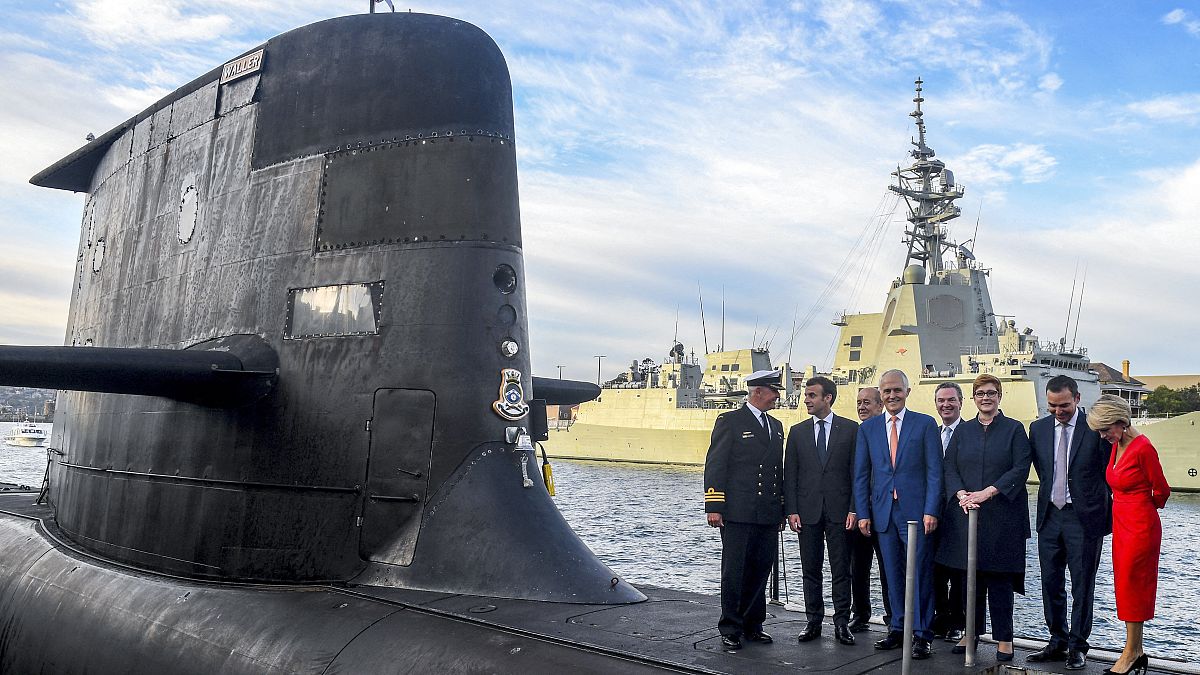 French President Emmanuel Macron (2/L) and then Australian Prime Minister Malcolm Turnbull (C) on HMAS Waller, an Australian Royal Navy submarine, Sydney, May 2, 2018.