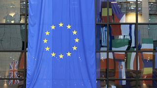 FILE: EU nations flags are mirrored in the windows of the EU Council headquarters ahead of a two-day EU summit in Brussels in March 2008