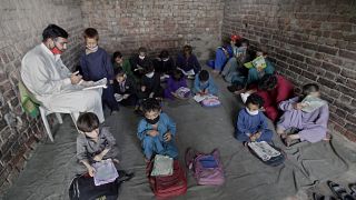 Afghan refugee children attend a class on the outskirts of Lahore, Pakistan.
