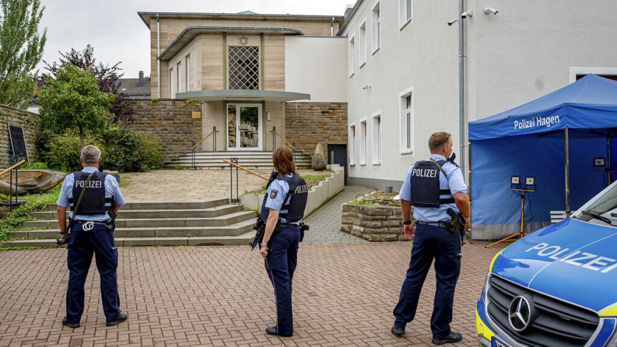 Police stand guard in front of the closed synagogue on Thursday morning