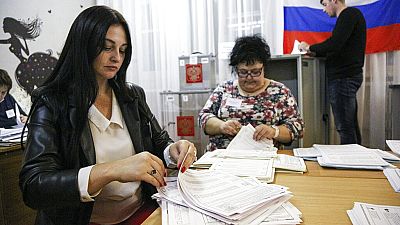 Members of an election commission count ballots after voting in Nikolayevka village outside Omsk