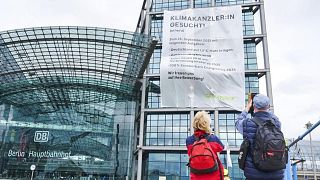 Greenpeace activists hanging a large banner reading "Climate Chancellor wanted!" at Berlin's main train station in Berlin, Germany, Friday, Sept. 17, 2021.