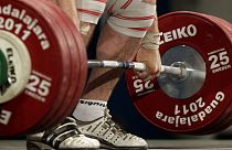 An athelete lifts 185 kg in the clean and jerk of a men's 105 kg weightlifting competition.