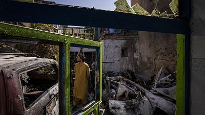 An Afghan inspects the damage of Ahmadi family house in Kabul, Afghanistan, Monday, Sept. 13, 2021. 