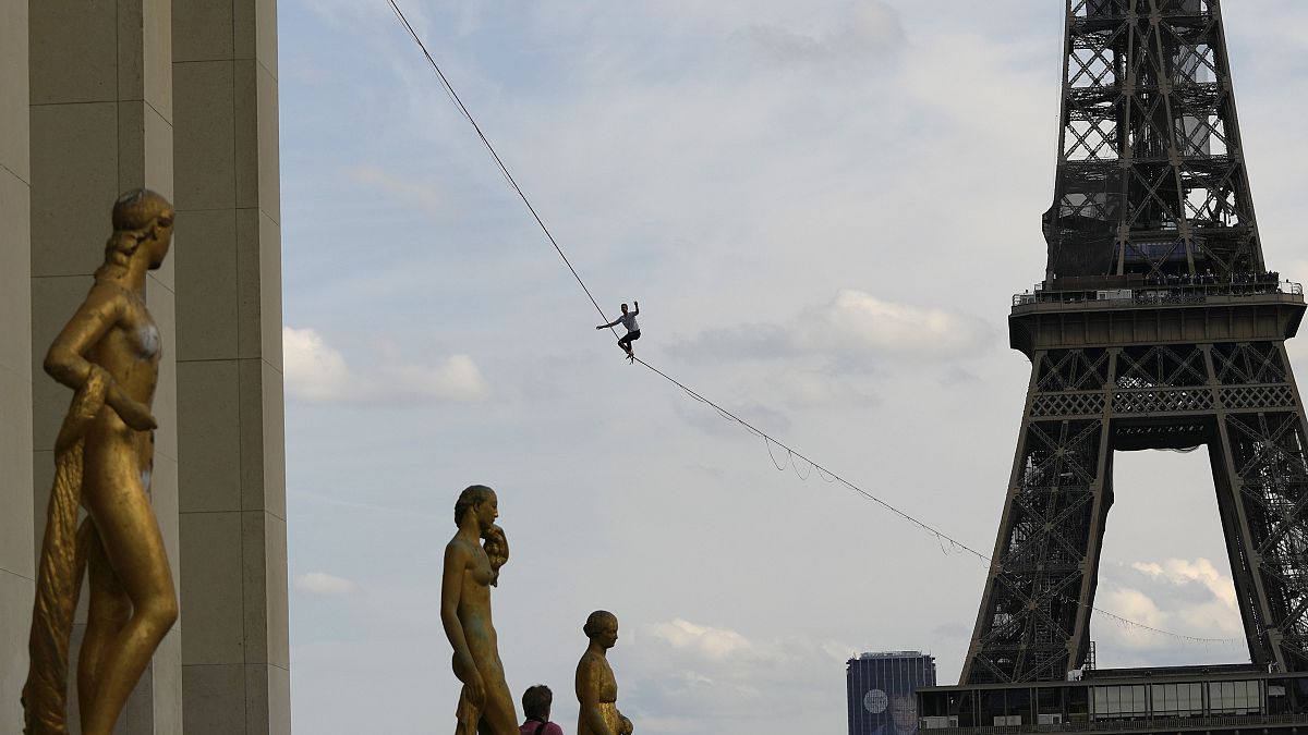 French acrobat Nathan Paulin attempts to walk a highline from the Eiffel Tower across the Seine River.