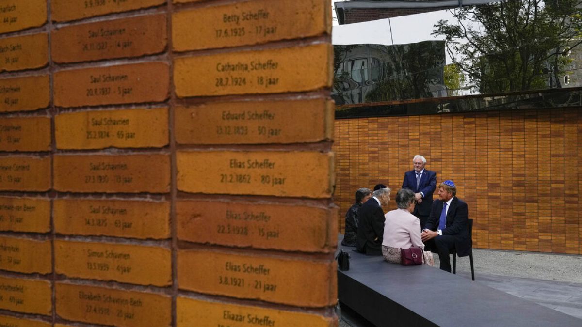  King Willem-Alexander, right, talks to Holocaust survivors and relatives after unveiling the new monument in Amsterdam's historic Jewish Quarter 
