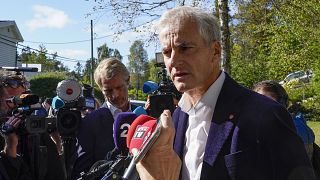 Norway’s Labor Party leader Jonas Gahr Store answers questions from reporters outside his home in Oslo.