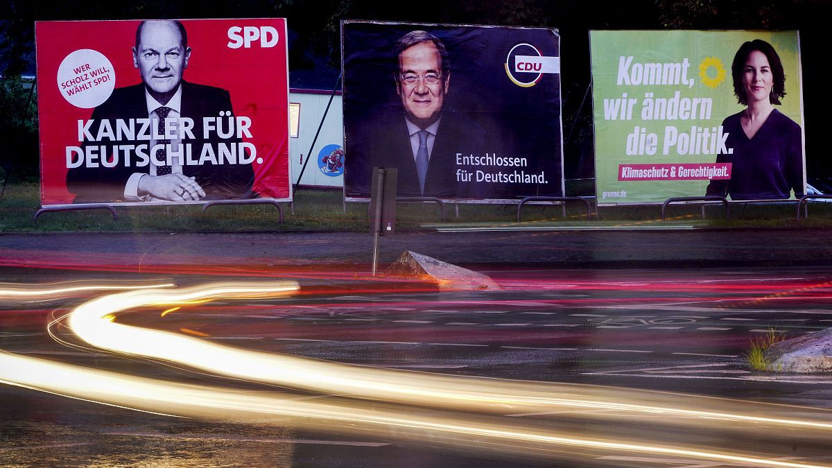 Three elections posters show candidates for chancellor in the German election.