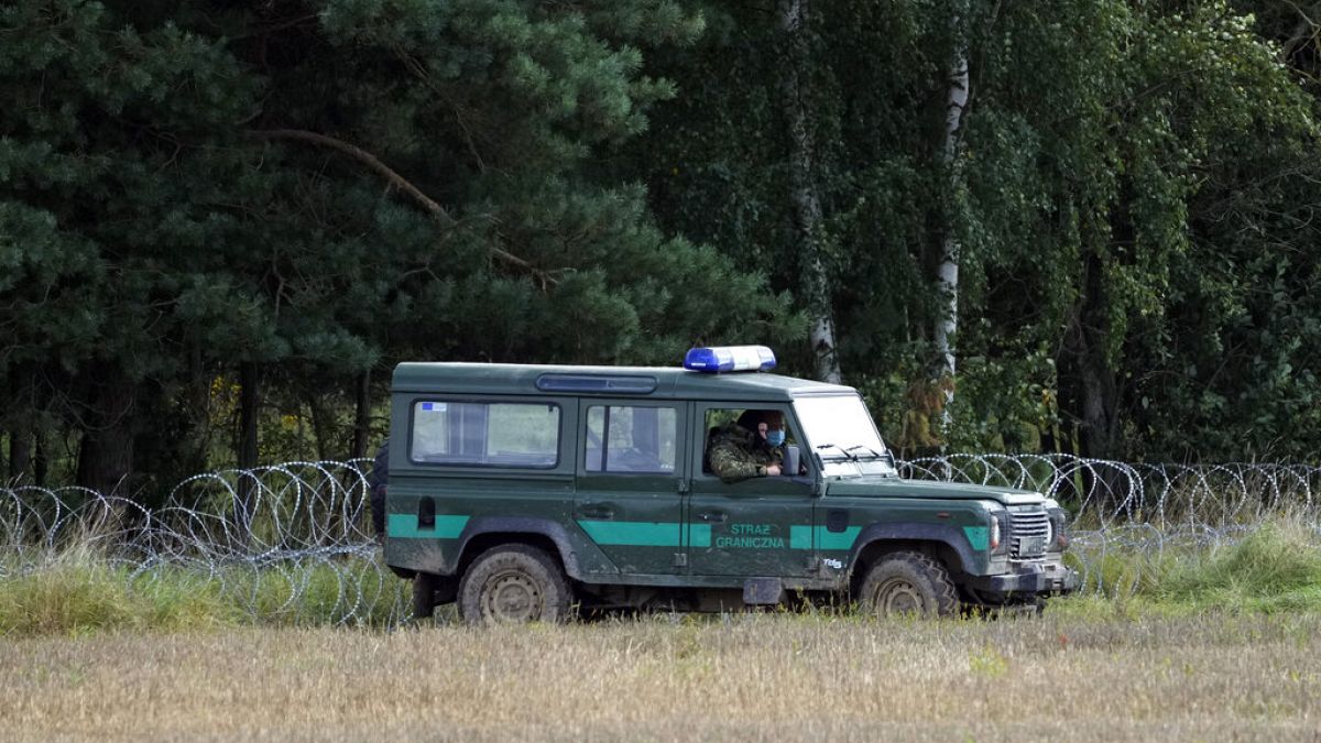 Polish border guards monitor an area along the border with Belarus in Usnarz Gorny, Poland.