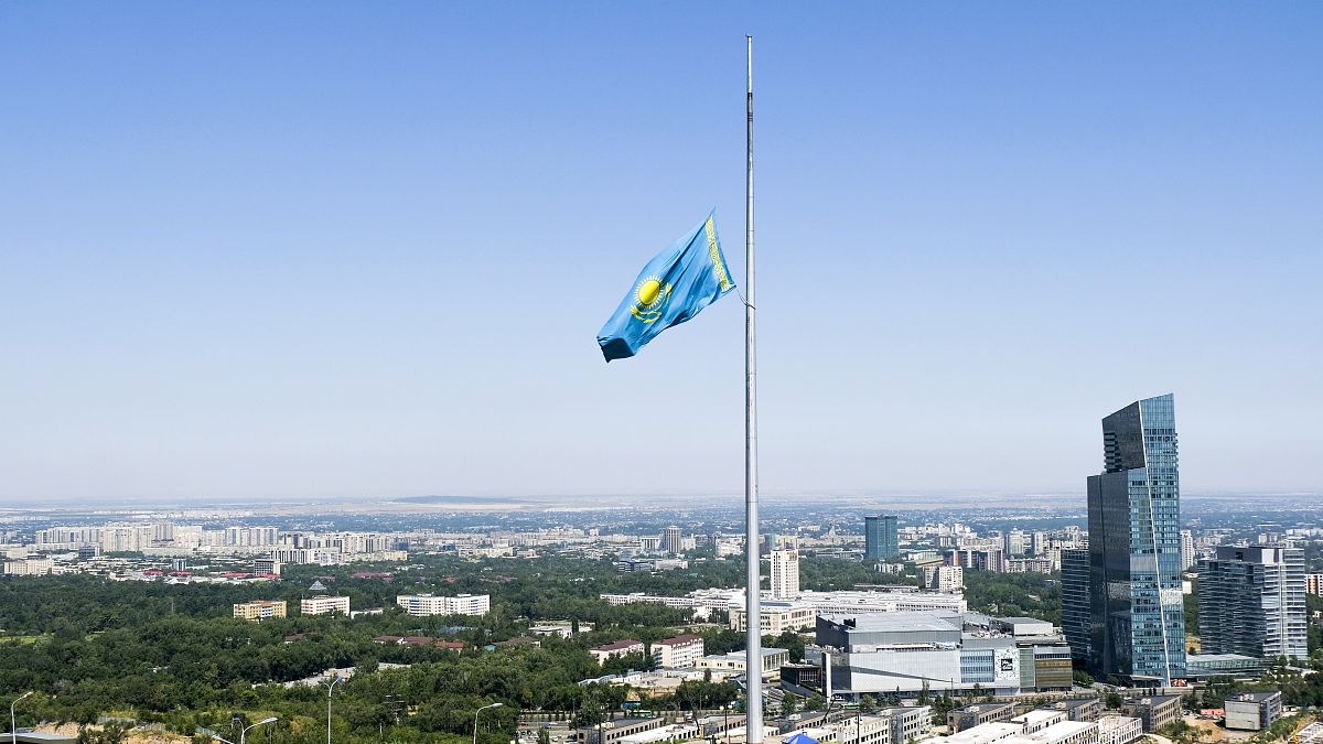 A Kazakhstan national flag flies at half staff over Almaty.