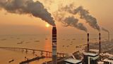The sun sets near a coal-fired power plant on the Yangtze River in Nantong in eastern China's Jiangsu province on Dec. 12, 2018