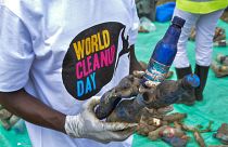 A World Cleanup Day volunteer collects and sorts plastic bottles removed from the River Wigwa in Kisumu, Kenya, Sept. 18, 2021.