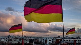 German flags wave in the wind on poles of a small circus in Frankfurt, Germany, Saturday, March 13, 2021.
