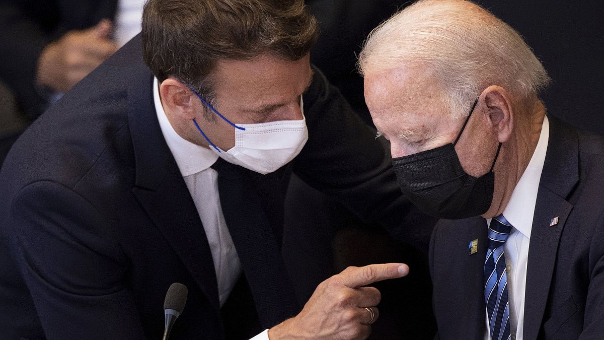 FILE - In this June 14, 2021 file photo, US President Joe Biden, right, speaks with French President Emmanuel Macron during a plenary session during a NATO summit. 