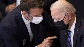 FILE - In this June 14, 2021 file photo, US President Joe Biden, right, speaks with French President Emmanuel Macron during a plenary session during a NATO summit. 