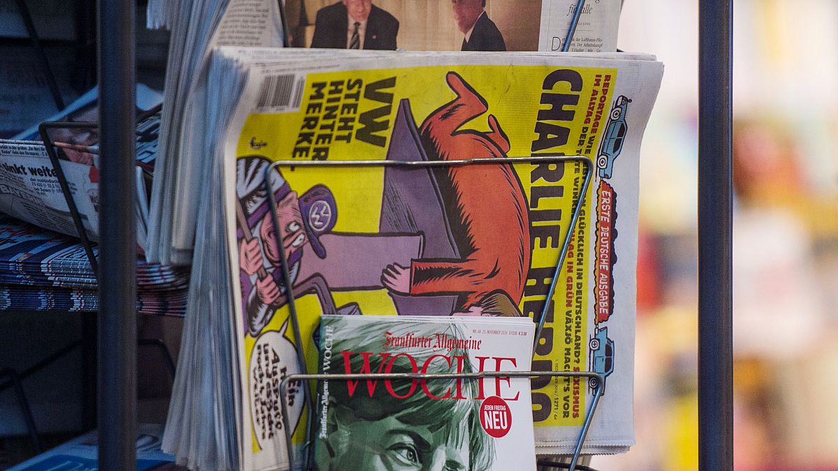 Copies of the French satirical magazine Charlie Hebdo sit at a newsagent's in Stuttgart.