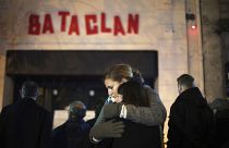 Women hug in front of the Bataclan concert hall in Paris, as France marked the anniversary of Islamic extremists' coordinated attacks on Paris, Nov. 13, 2016.
