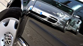 Oct 27, 2007 file picture shows a Porsche sports car. reflected in the door of a Volkswagen compact car in Frankfurt, Germany. 