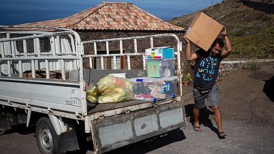 Edrey Concepcion loads his van with the neighbours' belongings as he helps during the evacuation of residents in Tacande due to the volcanic eruption in Cumbre Vieja.