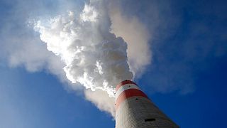 In this photo taken Wednesday, Oct. 3, 2018, smoke rises from the chimney of Serbia's main coal-fired power station near Kostolac, Serbia