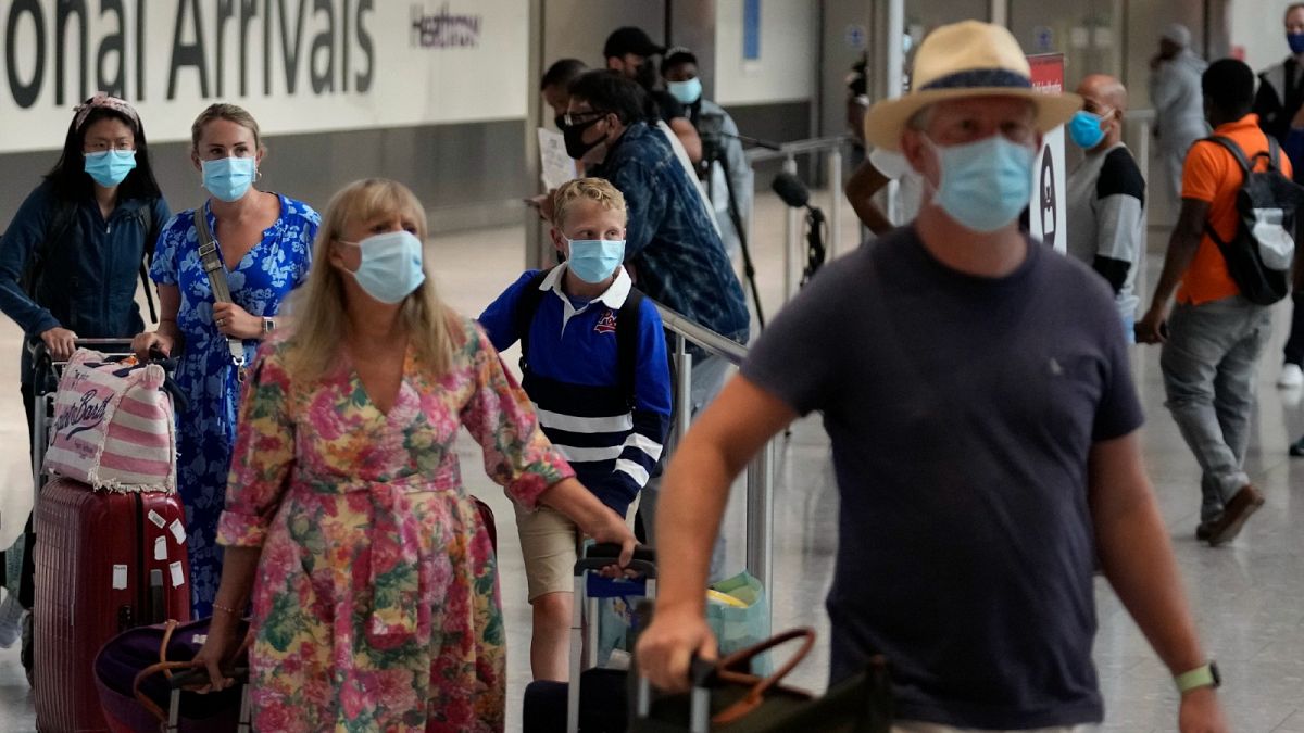Passengers arrive at Terminal 5 of Heathrow Airport in London, Monday, Aug. 2, 2021