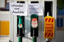 Hand written signs are stuck to a petrol pump with no fuel available at a Shell filling station in Manchester