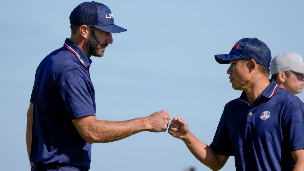 Team USA's Dustin Johnson and Collin Morikawa celebrate during their foursomes match on Saturday.