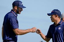 Team USA's Dustin Johnson and Collin Morikawa celebrate during their foursomes match on Saturday.