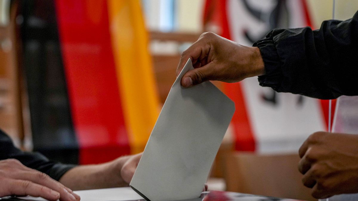 A man casts his ballot for the German elections in a polling station in Berlin, Germany, Sept. 26, 2021. 