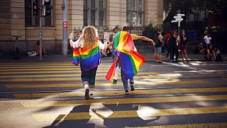 In this Saturday, Sept. 4, 2021 file photo, people take part in the Zurich Pride parade in Zurich, Switzerland