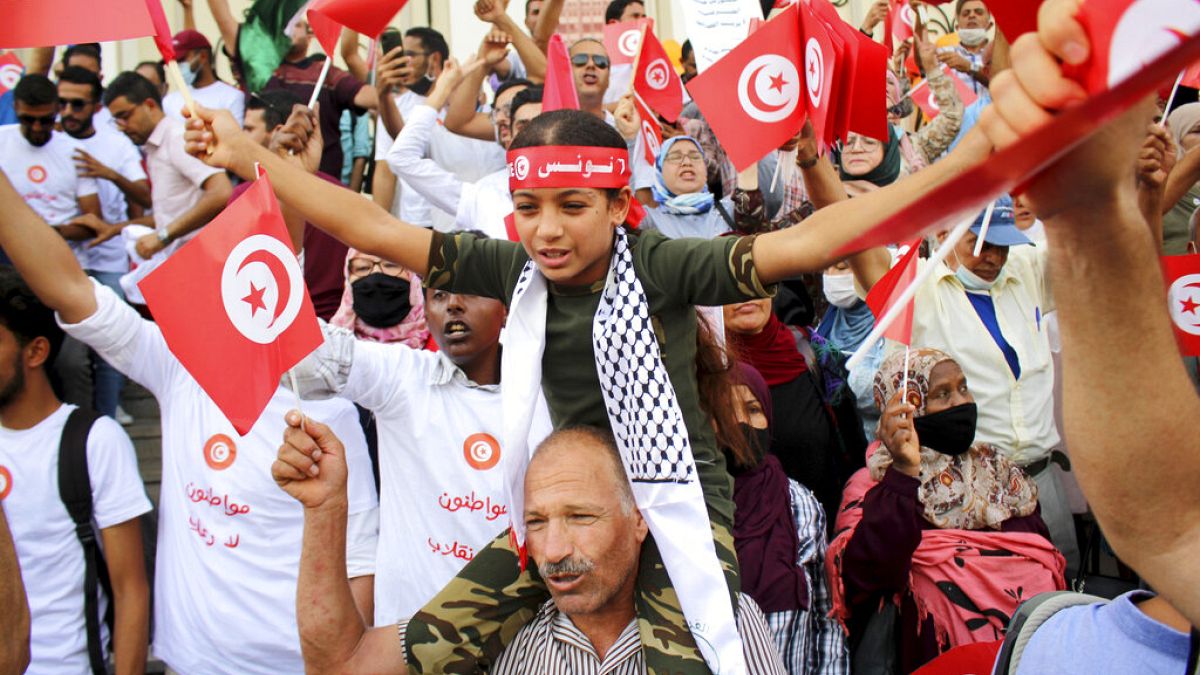 Demonstrators attend a protest against Tunisian President Kais Saied in Tunis on September 26