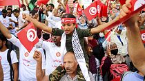 Demonstrators attend a protest against Tunisian President Kais Saied in Tunis on September 26
