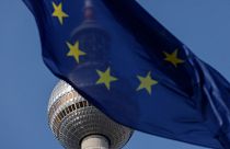 The European Union flag flutters with the landmark Television Tower in the background, in Berlin
