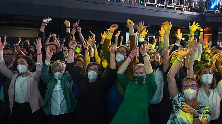 Members and supporters of the Green Party (Die Gruenen) gesture at the Green Party event after the close of polling stations.