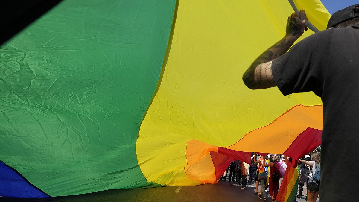 A rainbow flag is waved at a Pride march in the Polish city of Czestochowa.