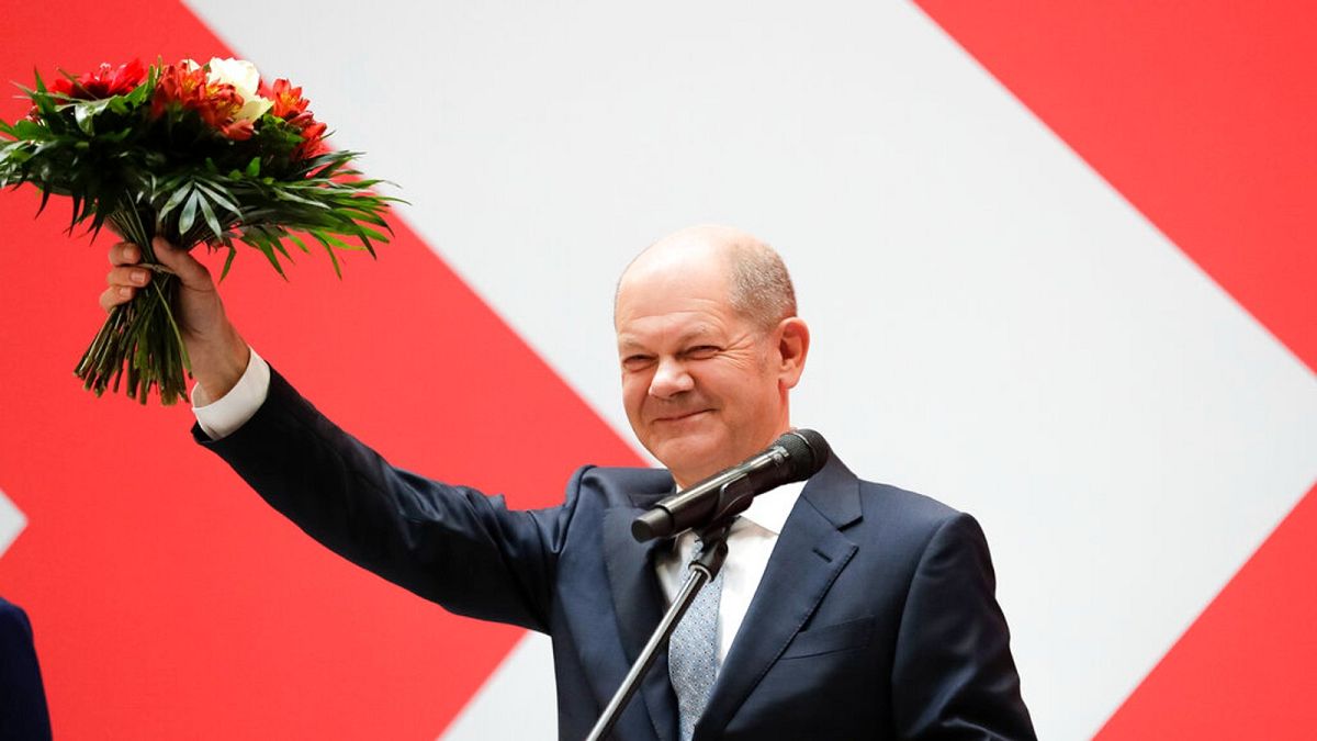 Olaf Scholz, top candidate for chancellor of the Social Democratic Party (SPD), holds a bunch of flowers after a press statement at the party's headquarter in Berlin, Germany