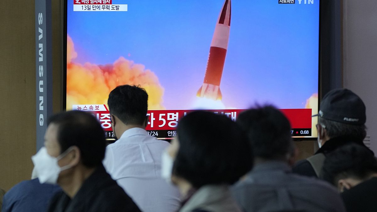 People watch a TV showing a file image of North Korea's missile launch during a news program at the Seoul Railway Station in Seoul, South Korea, Sept. 28, 2021. 