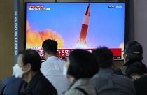 People watch a TV showing a file image of North Korea's missile launch during a news program at the Seoul Railway Station in Seoul, South Korea, Sept. 28, 2021. 