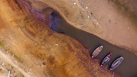 Boats in sitting on the bed of the Paraguay river amid a historic drought that is affecting its levels, in Chaco-i, Paraguay, Monday, Sept. 20, 2021.