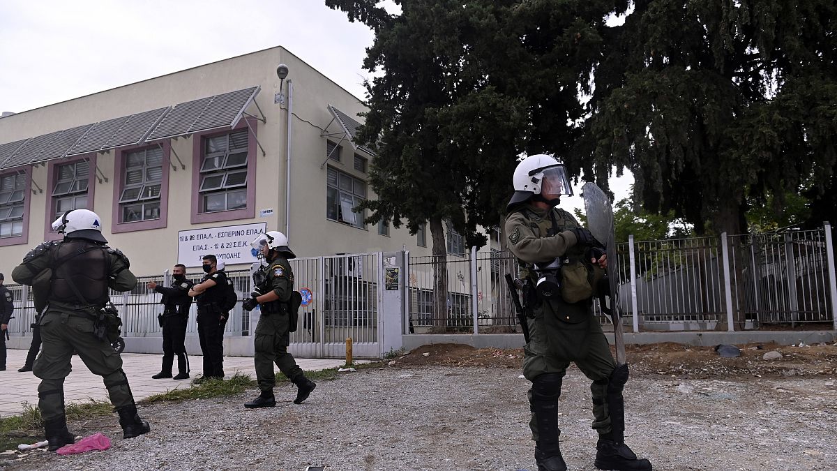 Riot police guard outside a vocational high school after clashes in the northern city of Thessaloniki.